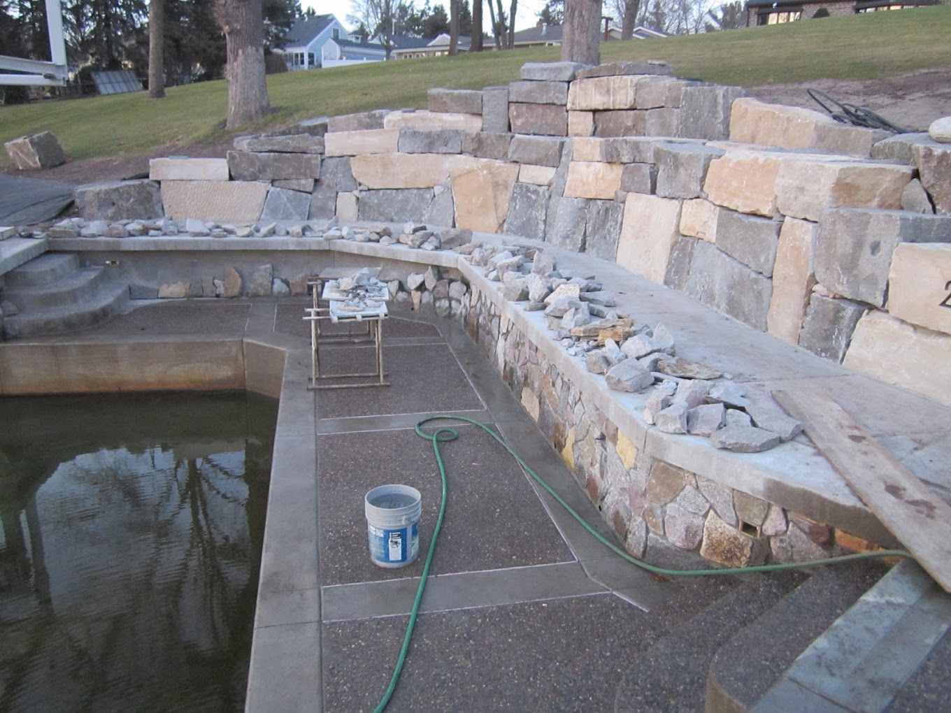 Custom stone retaining wall and landscape masonry